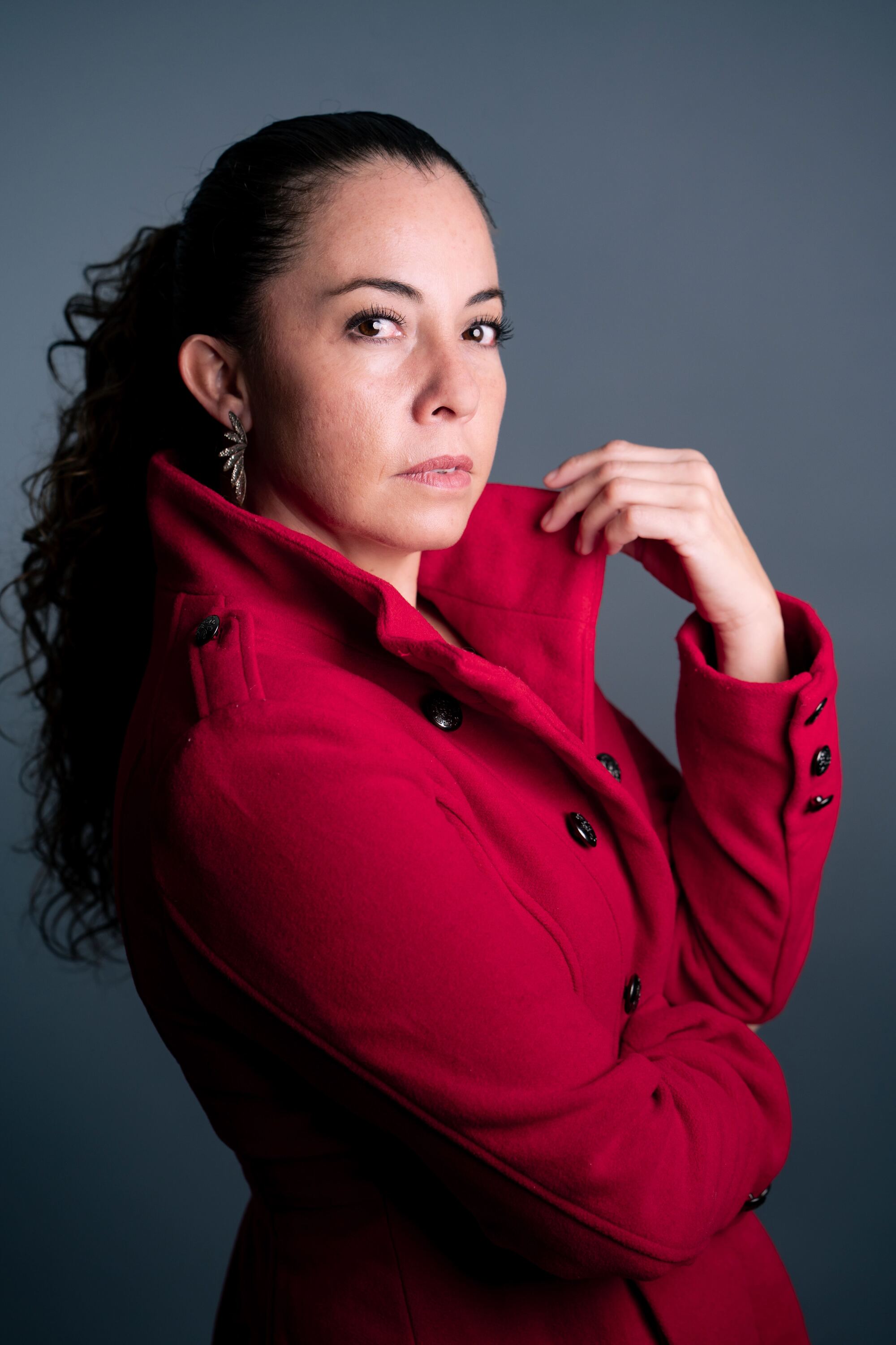 Alpha in a red coat, studio portrait